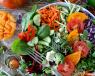 A plate full of vegetables and fruits