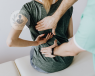 A young woman with back pain undergoing a clinical examination