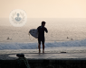 man on the beach with surfboard 