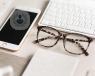 glasses and a phone on a desk