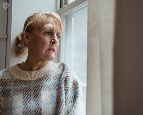 Older woman thinking about the signs of ovarian cancer.