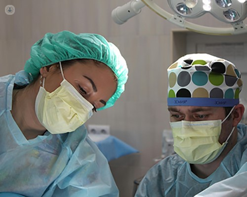 Surgeons undertaking a robotic hip replacement procedure.