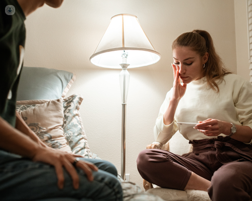 Woman with tubal factor infertility looking at pregnancy test.