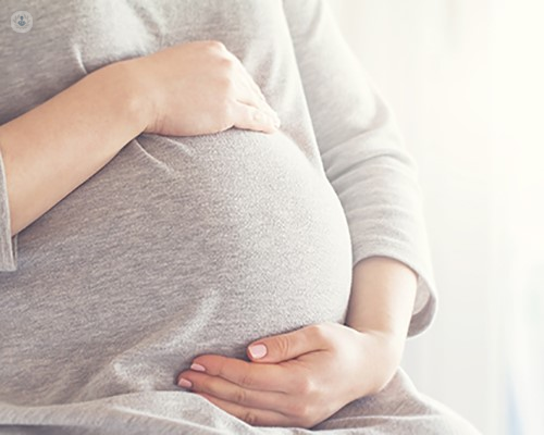 Pregnant woman thinking about noninvasic prenatal testing (NIPT)